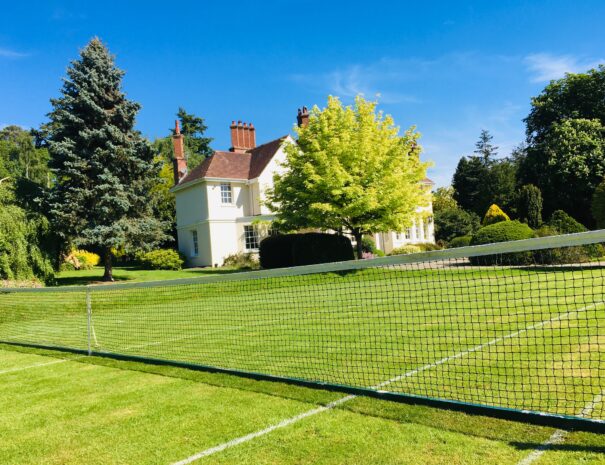 Summer tennis lawn at Ludlow Manor House