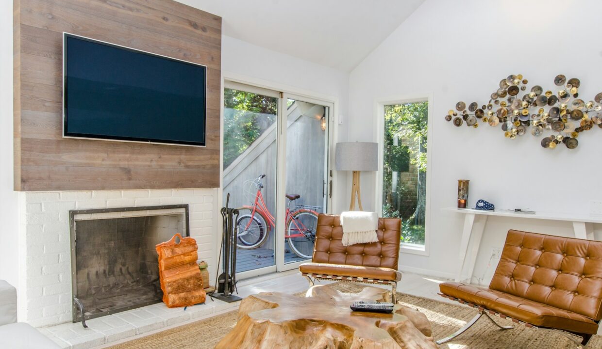 two tufted brown leather chairs in front of brown wood stump center table