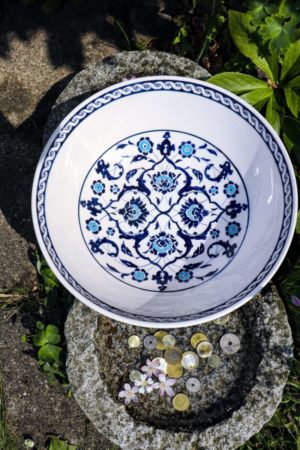 A handmade bowl in white with blue and turqouise floral motifs, in Ottoman style. Lead free and food safe