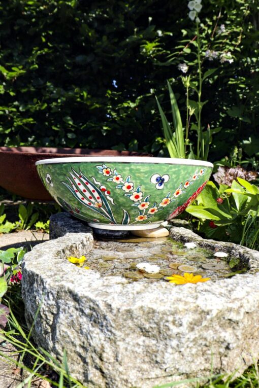 Handmade ceramic bowl with adorable floral motifs on an olive-green backdrop. Foodsafe and lead-free