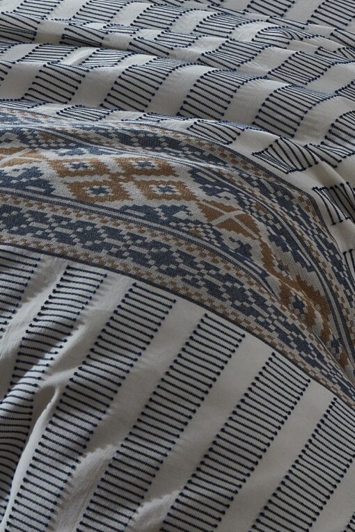 Embroidery details in blue and golden colors from an organic cotton duvet cover set - GOTS certified