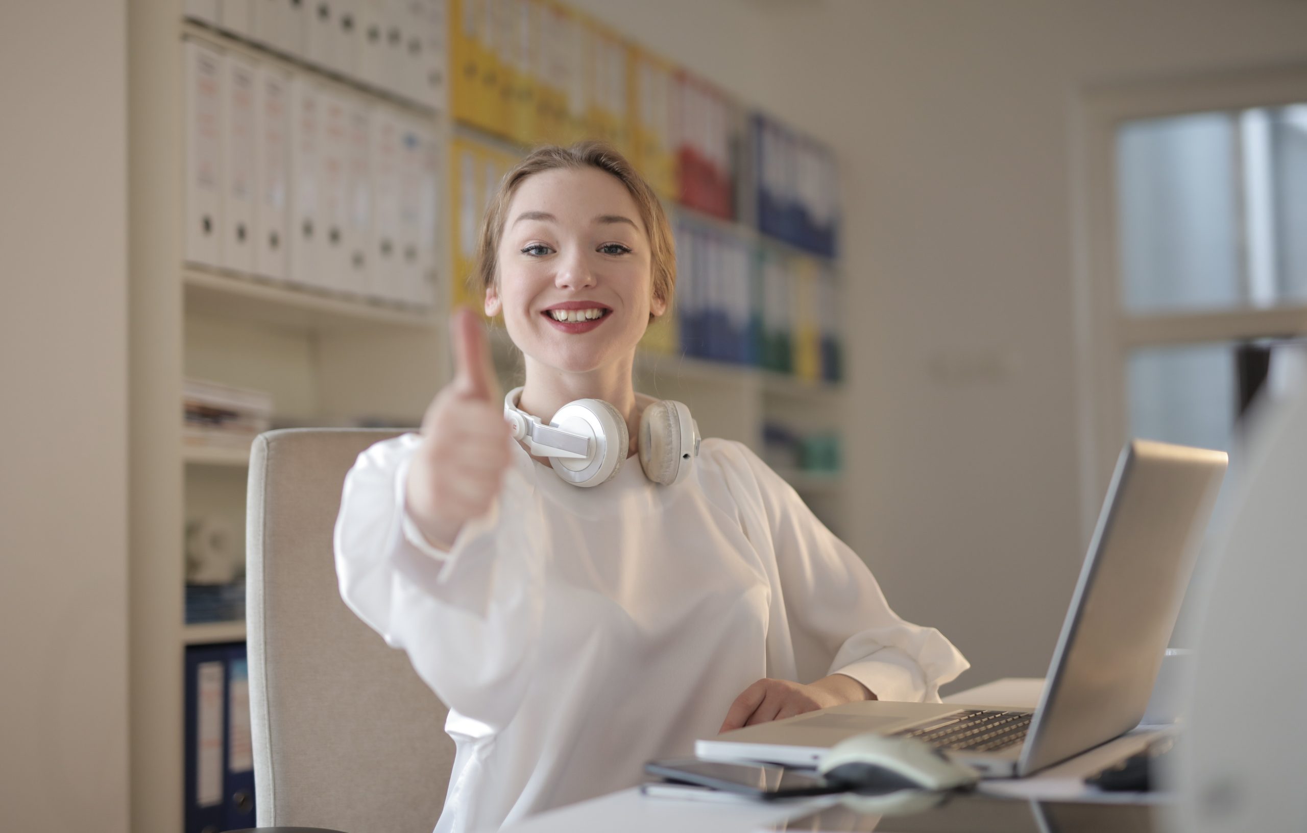 woman wearing white top while doing thumbs up 3790805 scaled