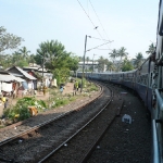 Arriving in a Keralan town, clothes drying next to the tracks