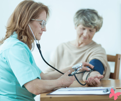 Doctor checking the blood pressure of a patient, wondering how she can help her naturally lower her high blood pressure