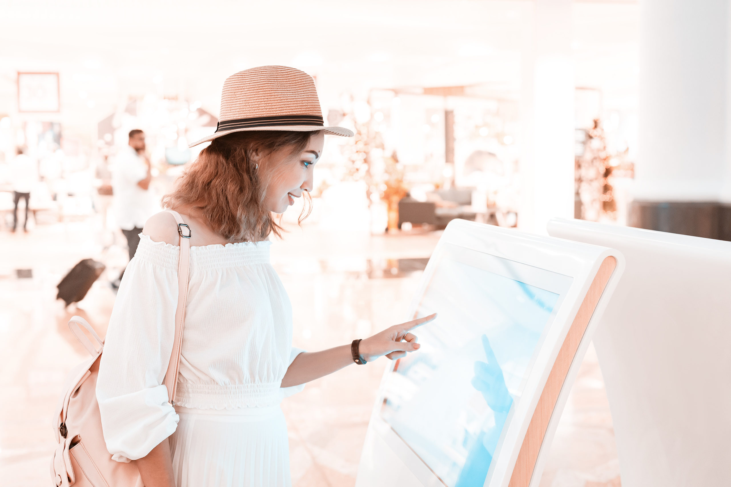 commercial-and-hospitality-Design-by-MDfx-woman-wearing-white-using-digital-kiosk