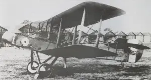 an old airplane is parked in the grass