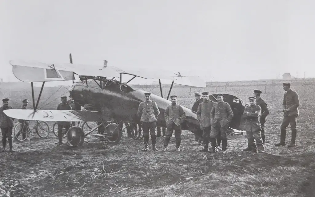 a group of men standing next to an airplane