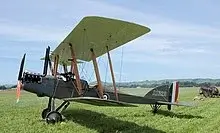 a small airplane sitting on top of a lush green field