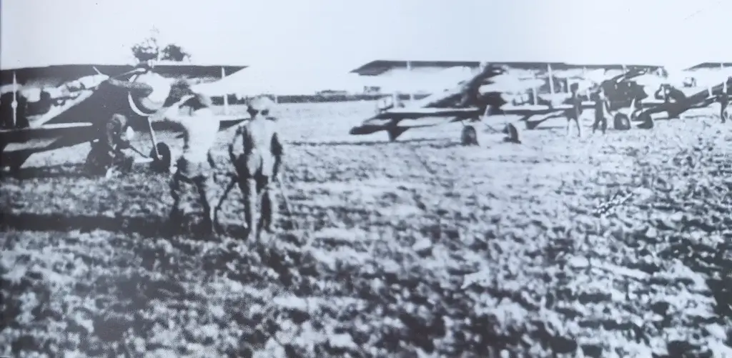 an old black and white photo of people standing in front of airplanes