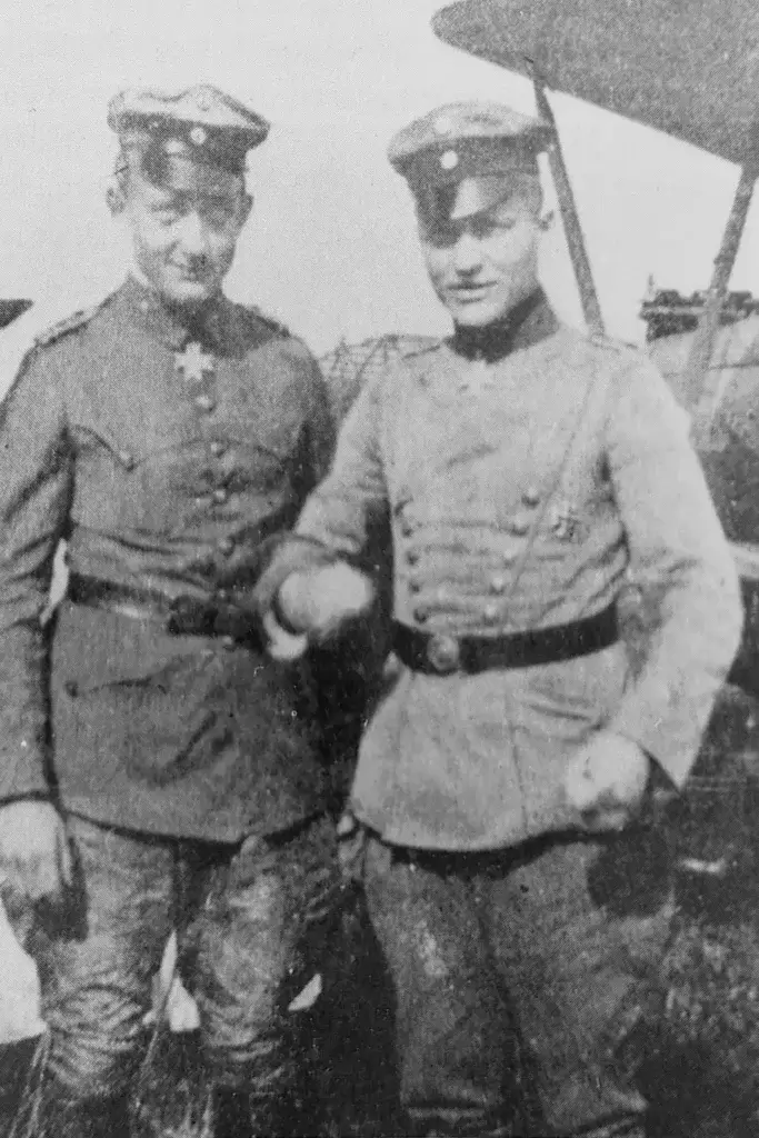 two men in uniforms standing next to each other