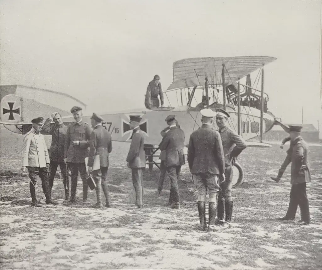 a group of men standing around an old airplane