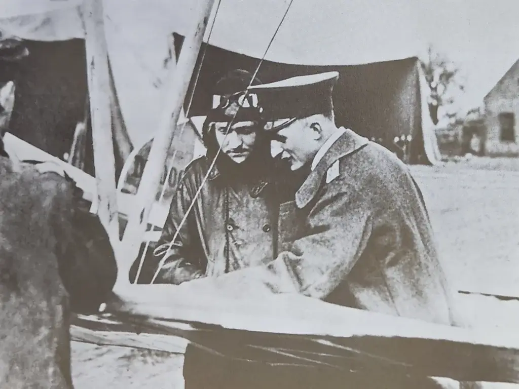 two men in military uniforms standing next to each other