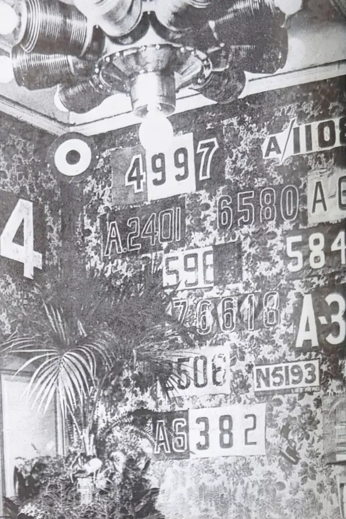 a black and white photo of an old gas station sign