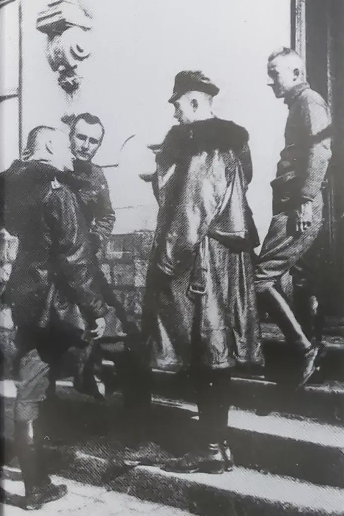 a group of men standing on top of a set of stairs