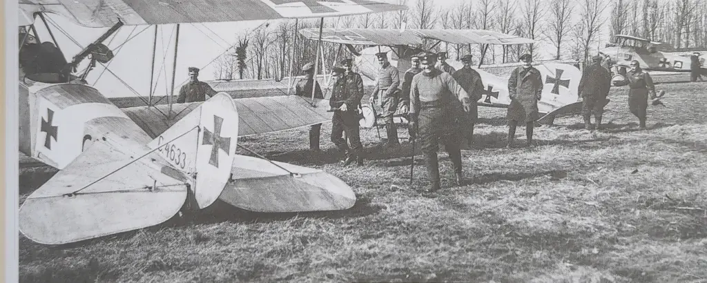 a group of men standing next to each other in front of an airplane