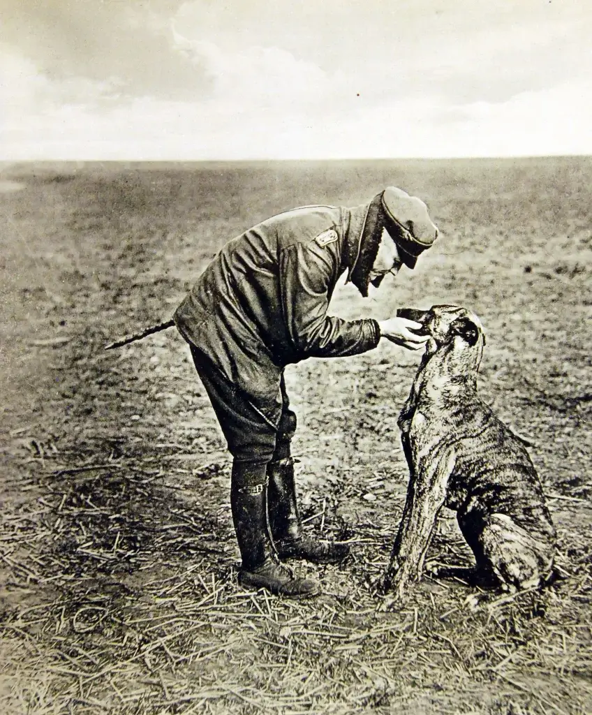 an old photo of a man with a dog