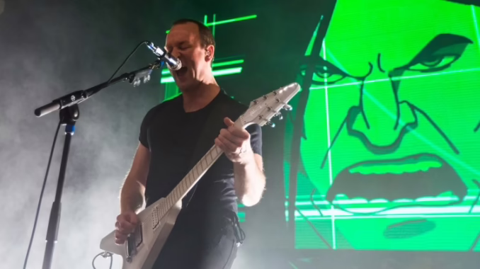 Brendon Small Dethklok photo Photo of Brendon Small of Dethklok on stage playing guitar and singing.