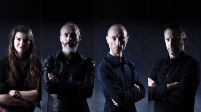 Amon-Sethis band photo A band portrait of four members standing side-by-side against a dark backdrop, each with their arms crossed.