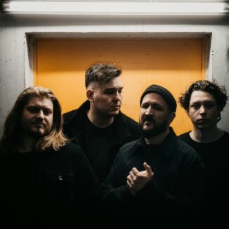 All four members of the band Senna standing together in a hall way