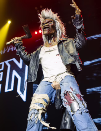 Eddie, Iron Maiden's mascot on stage, grabbed from behind by Brunce Dickinson.