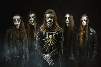 five adult men facing the camera wearing dark clotes and white face paint, dark background.