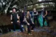 Five band members staring at the camera, wooded background