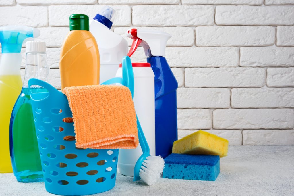 Basket with cleaning products on white background. Cleaning with supplies, cleaning service