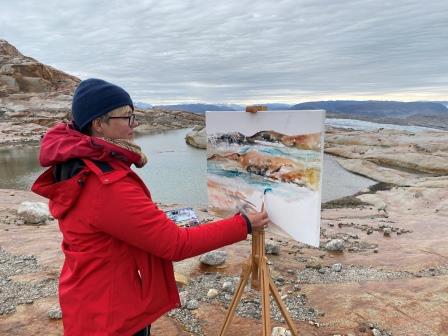 Art and Climate. Watercolor painting on the icesheet on Greenland. Artist Mette Hansgaard painting on the Icesheet after hicking down 15 km. September 2022