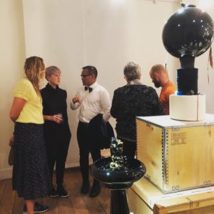 Erin Dickson in talk with colleagues on the opening night