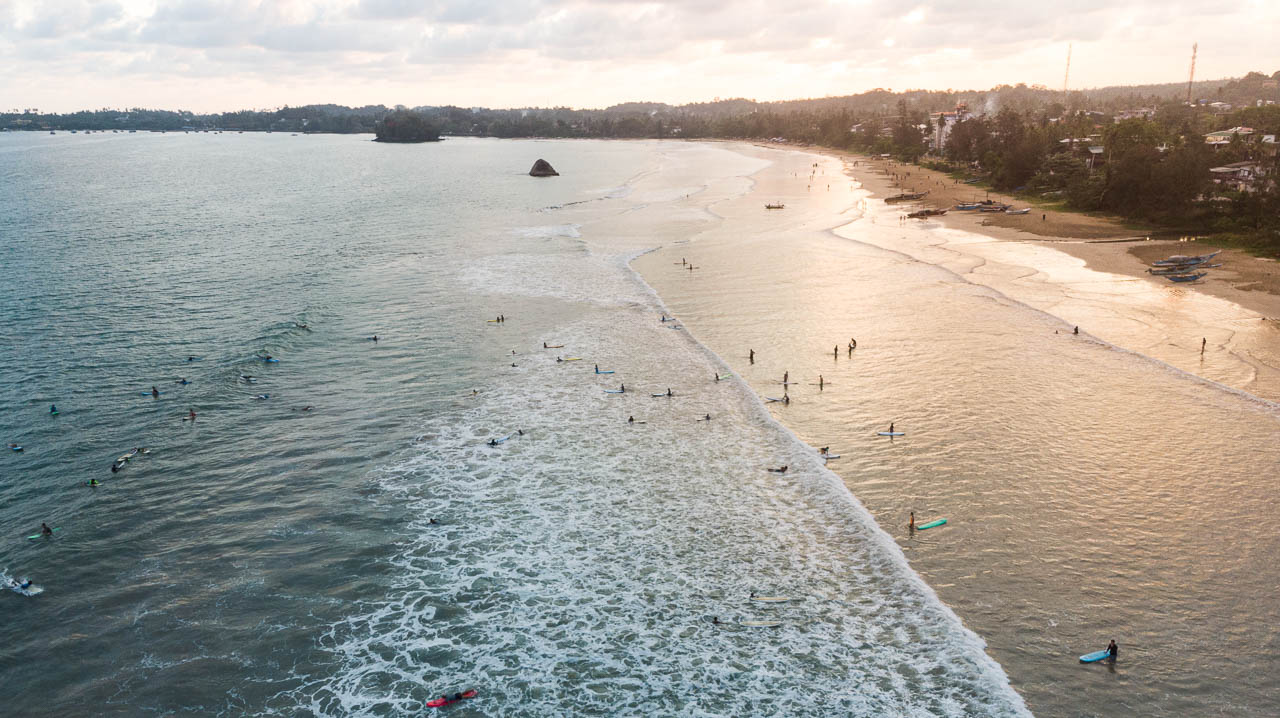 Surfer with sunset in weligama