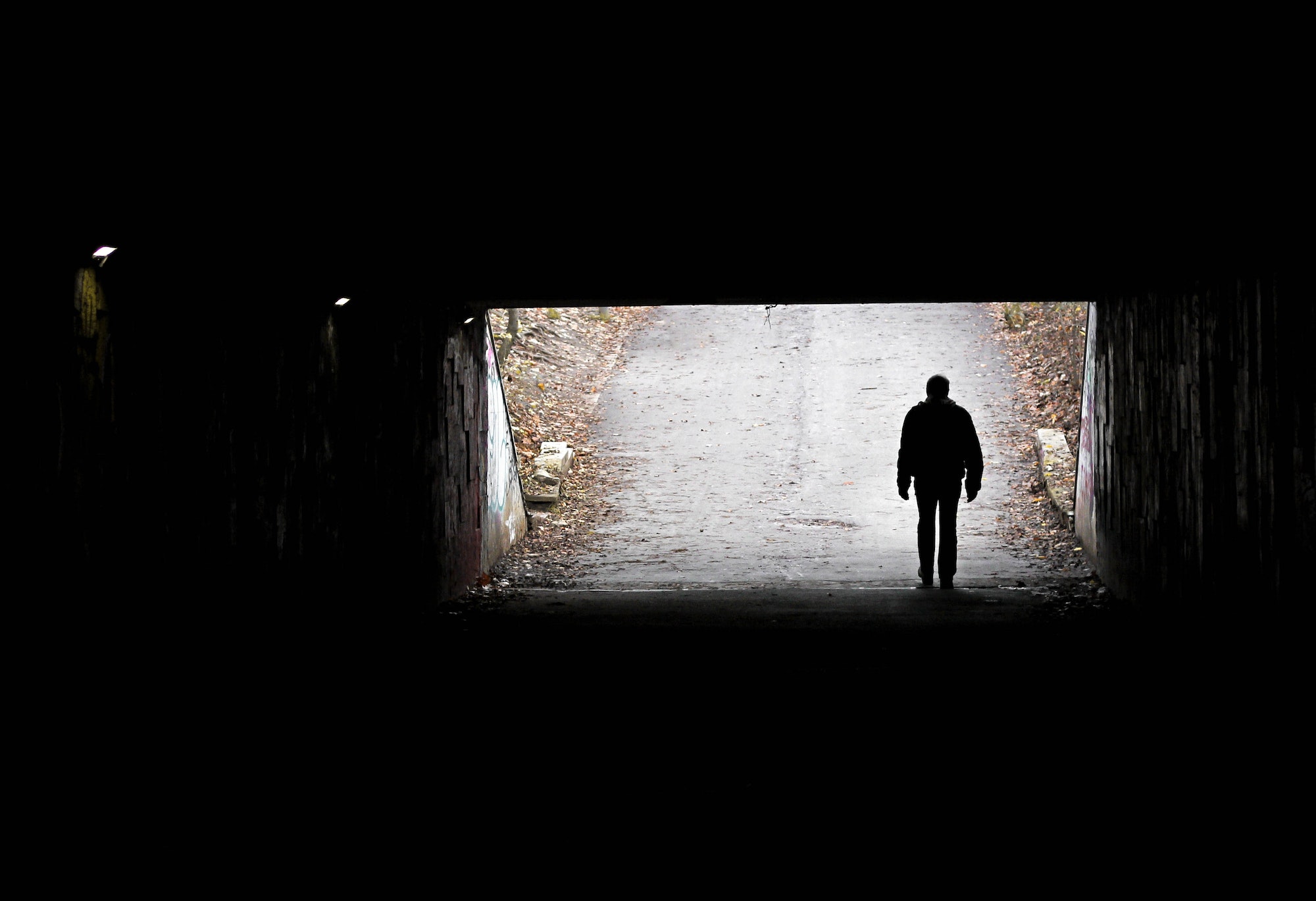 Silhouette of a man in the darkness of the tunnel