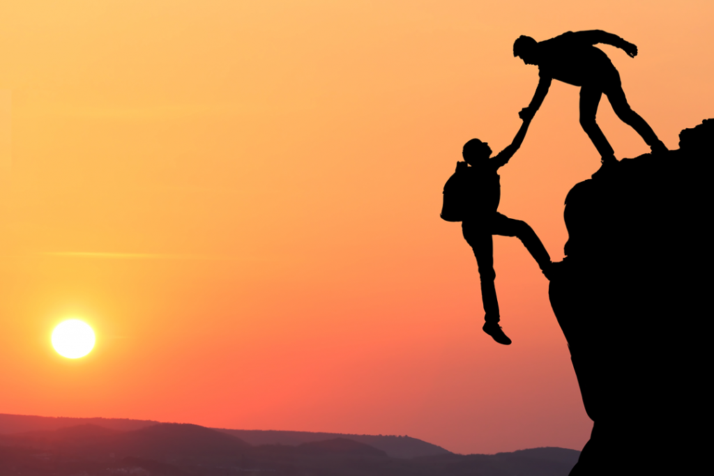 Shows two people on a mountain