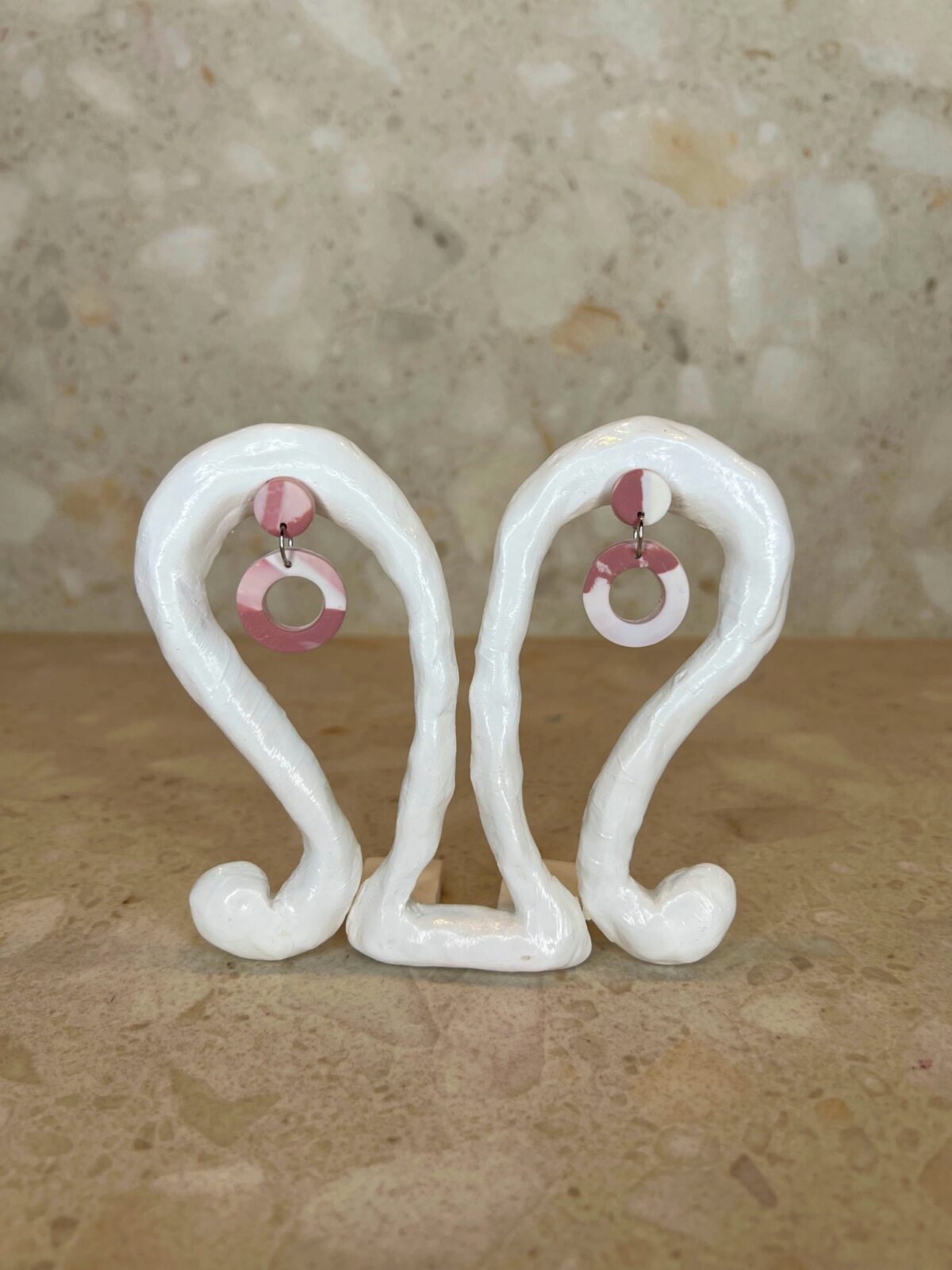 Handmade polymer clay ear studs in pink and white