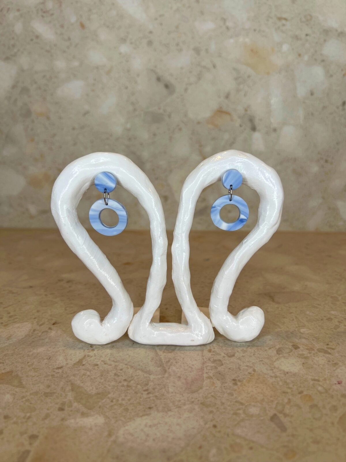 Handmade polymer clay ear studs in blue and white