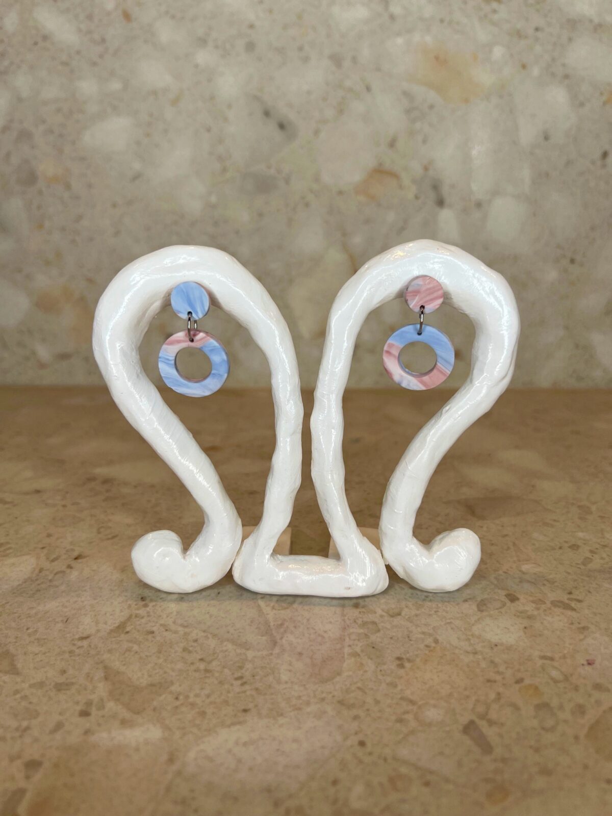 Handmade polymer clay ear studs in blue and pink