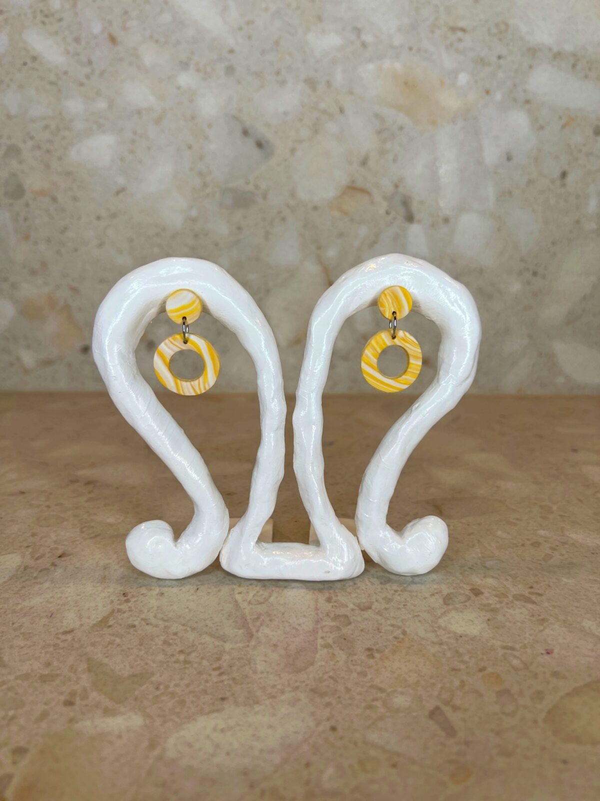 Handmade polymer clay ear studs in yellow and white