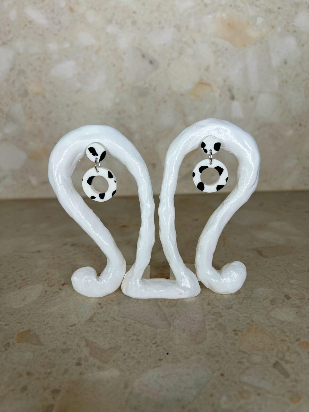 Handmade polymer clay ear studs in black and white