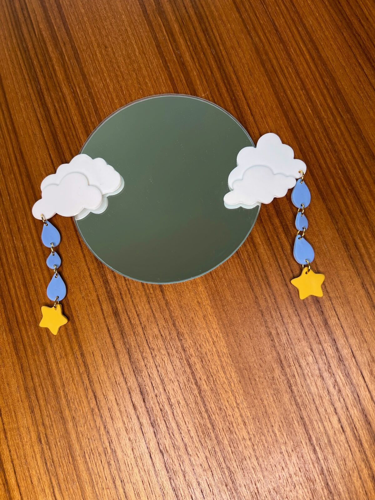 Mirror with handmade polymer clay clouds, rain and star decorations