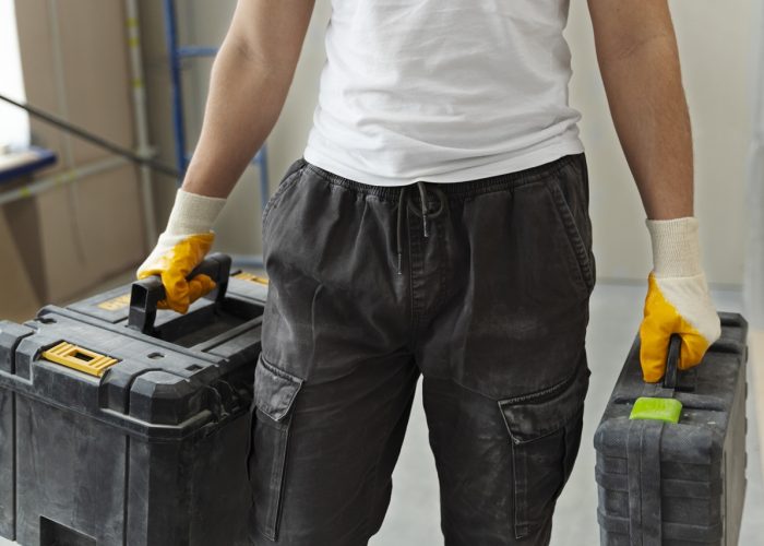 construction worker carrying containers