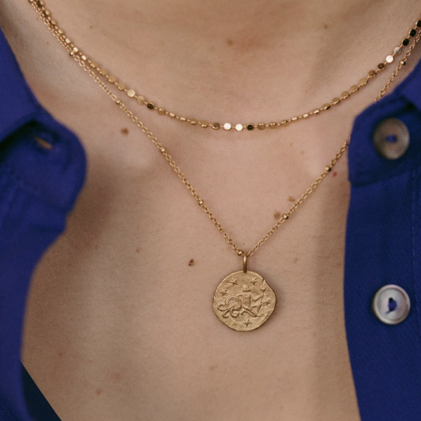 woman wearing the Aquarius Necklace by the brand Agapé Studio