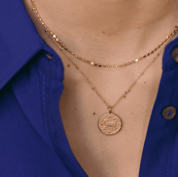 woman wearing the Aries Necklace by the brand Agapé Studio