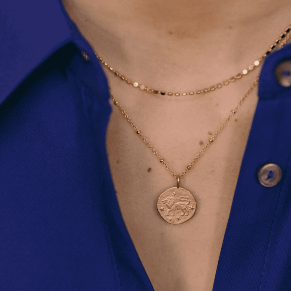 woman wearing the Leo Necklace by the brand Agapé Studio