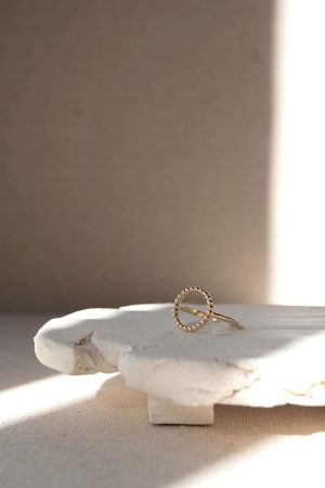 front view of the Theodora Ring by the brand Agapé Studio, shown on the Cloud Tray by Marlies Huybs