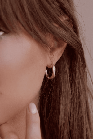 woman wearing the Zephir Earrings by the brand Agapé Studio