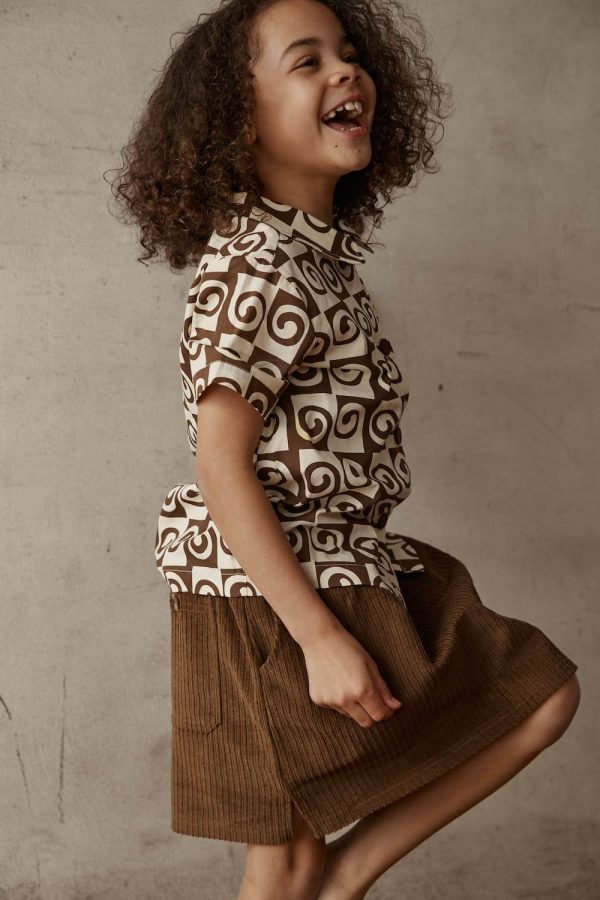 girl wearing the Barney Skirt in Brown by the brand Alfred