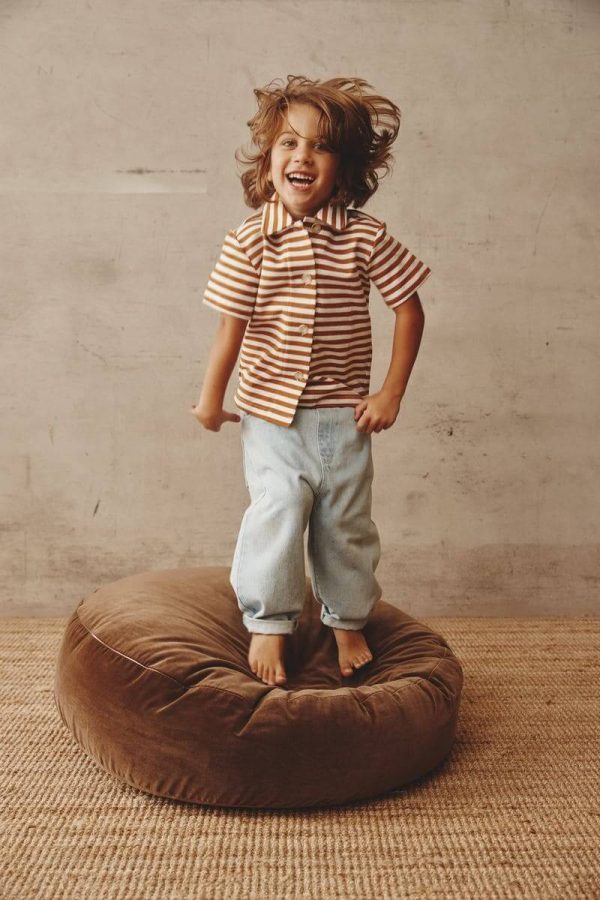 boy wearing the Franklin Jeans in Blue Denim paired with the Lucia Shirt by the brand Alfred