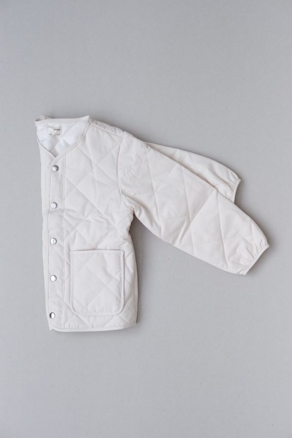 flatlay of the Isobel Jacket in Cream by the brand Alfred
