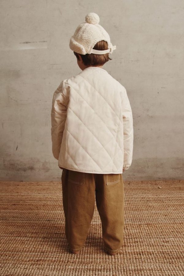 boy wearing the Isobel Jacket in Cream paired with the Arthur Worker Pants by the brand Alfred