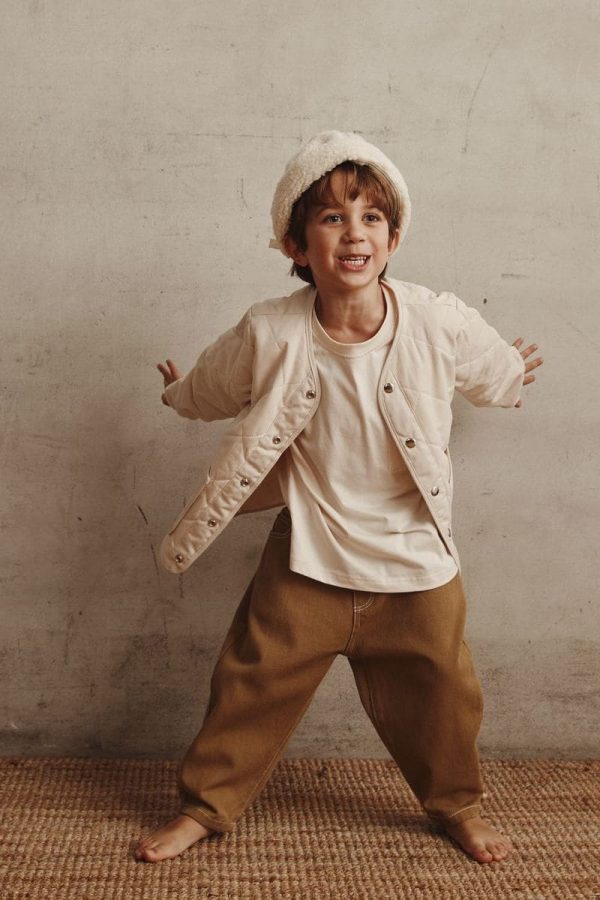 boy wearing the Isobel Jacket in Cream paired with the Walter Tee & the Arthur Worker Pants by the brand Alfred
