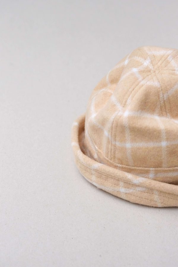 flatlay of the Joan Check Bucket Hat in beige by the brand Alfred